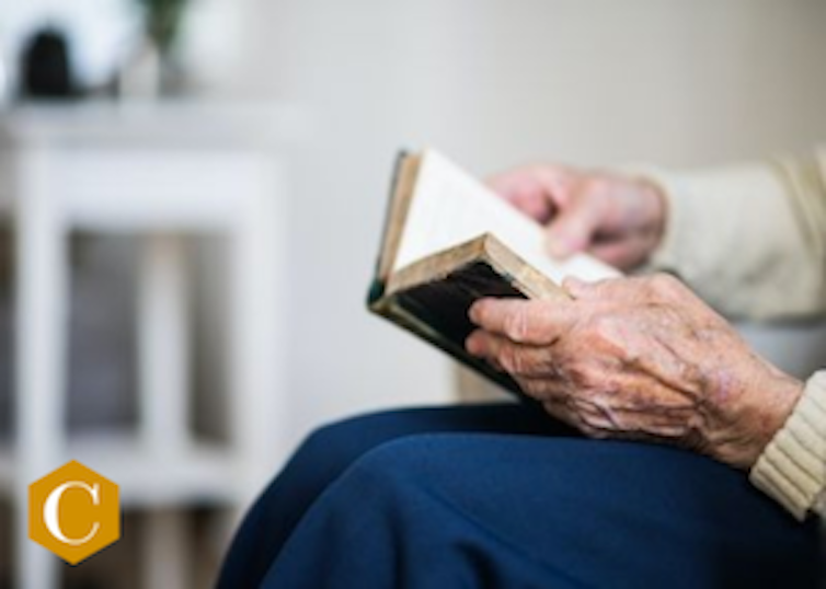 elderly hands holding a book