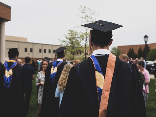 back image of student in graduation gown