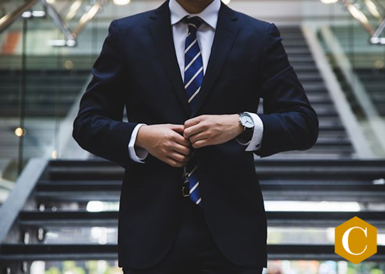 image of male buttoning suit