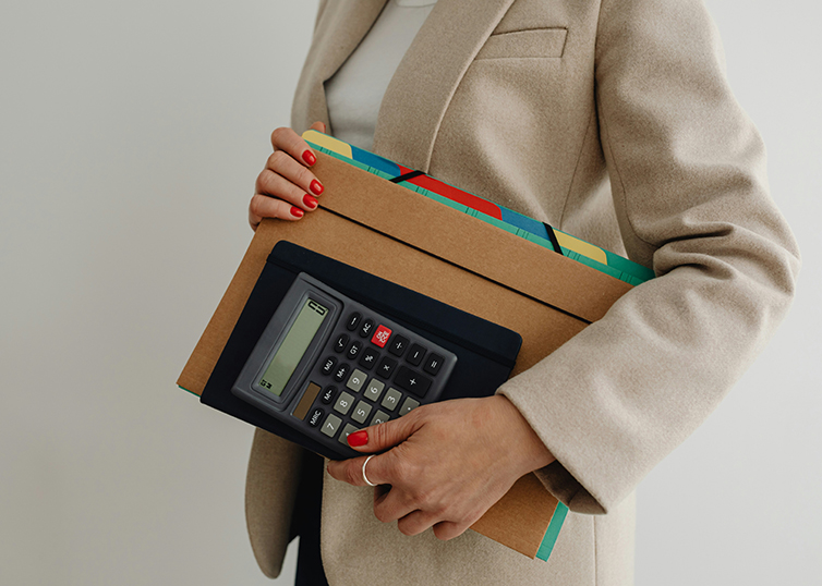 Women holding folders and calculator